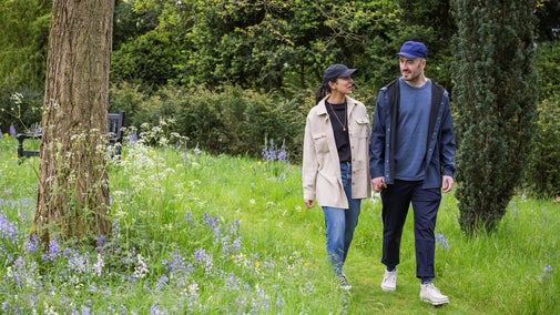 Man and woman walking in the garden at Ickworth in spring